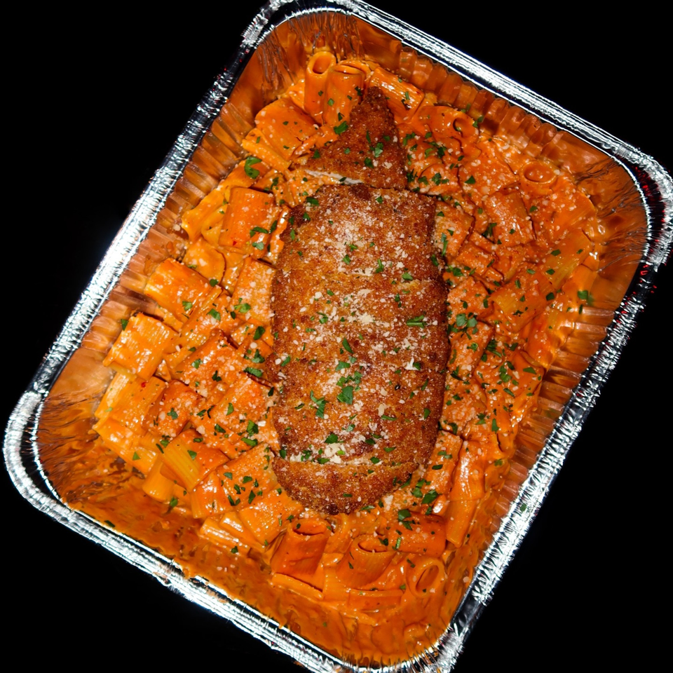 Nunzi's rigatoni with vodka sauce, topped with a breaded chicken cutlet, parmesan, and parsley.