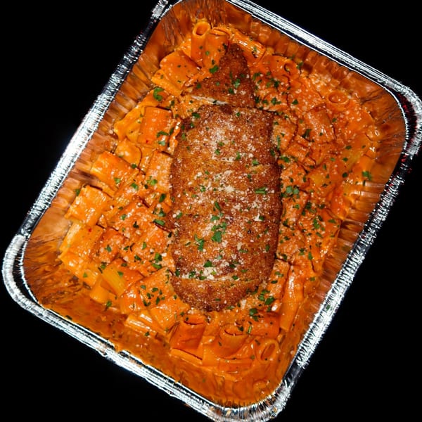 Nunzi's rigatoni with vodka sauce and a breaded chicken cutlet in a foil pan.
