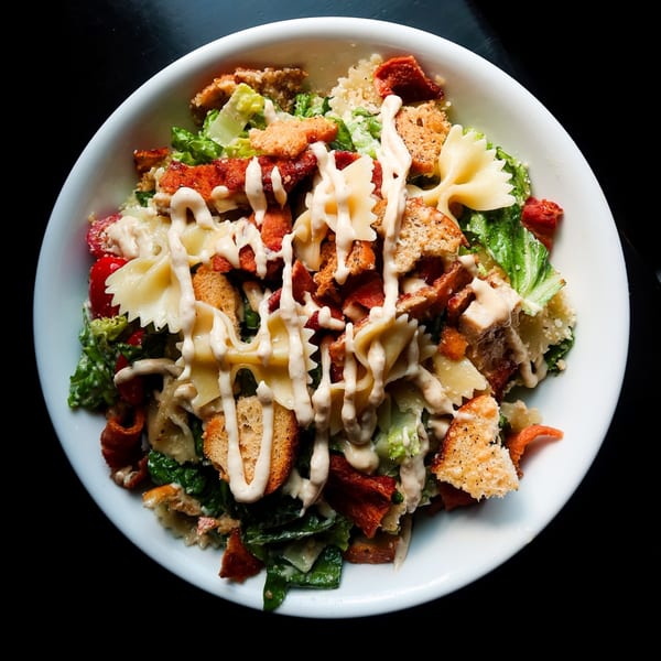 Nunzi's Italian salad with farfalle pasta, croutons, bacon, lettuce, and creamy dressing.